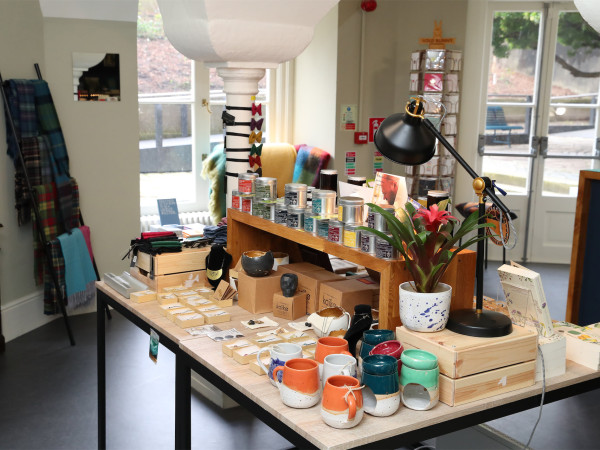 Photograph of items, including mugs and jewellery, in the MoLI giftshop.