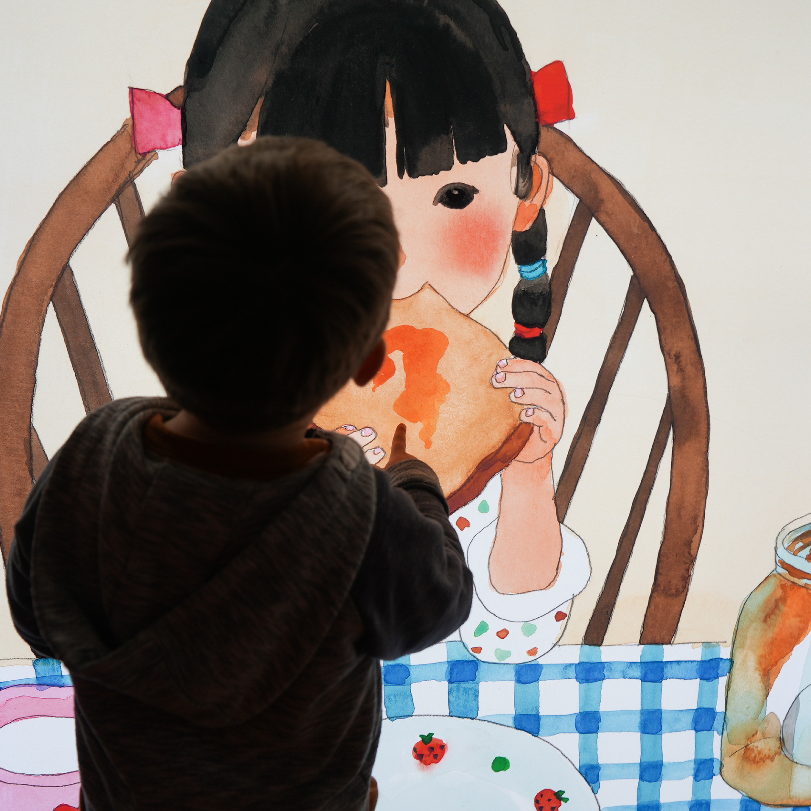 Photograph of a child in front of an illustration in the 'What I Like Most' exhibition at MoLI.