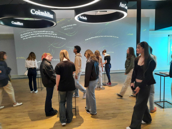 Photograph of several people at MoLI's 'Riverrun of Language' exhibition.